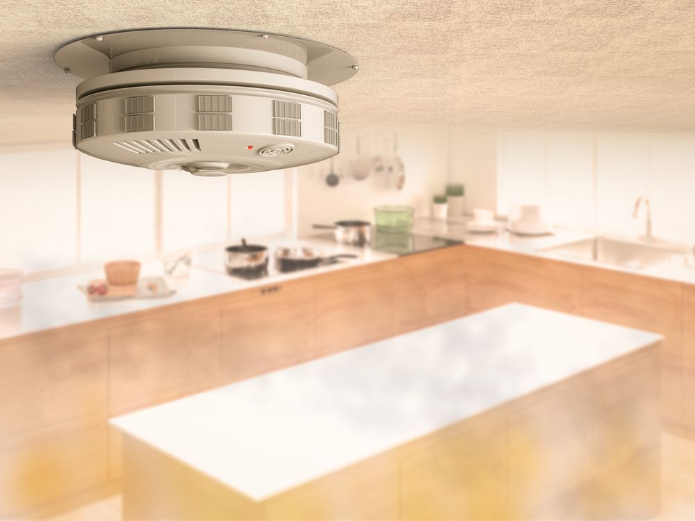A Smoke Detector is Mounted to the Ceiling of a Kitchen — Alert Smoke Alarm Compliance in Bundaberg, QLD