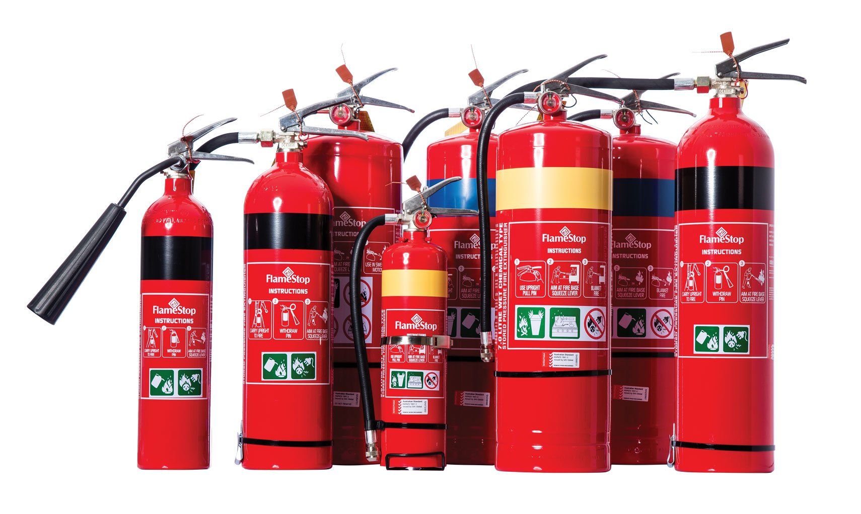 Assorted red fire extinguishers lined up on a white background — Fitzroy Fire and Safety in Kawana, QLD