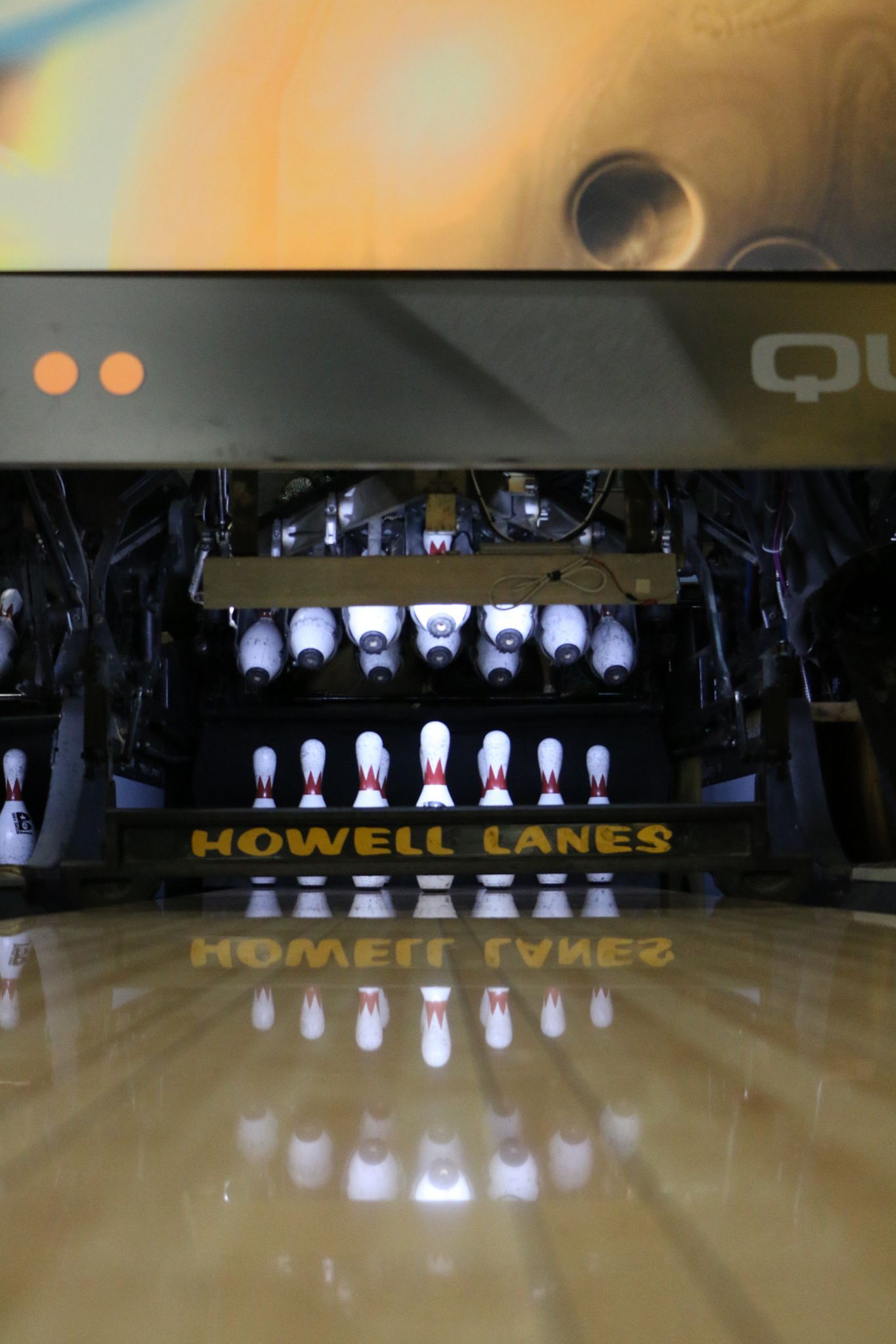 Bowling pins set up with Howell Lanes sign at pinsetter area