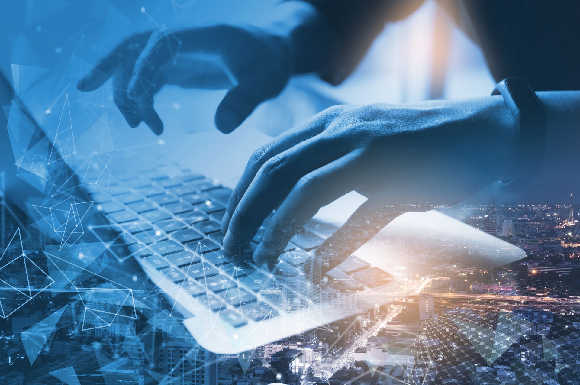 Hands typing on a laptop keyboard with a blue digital network overlay