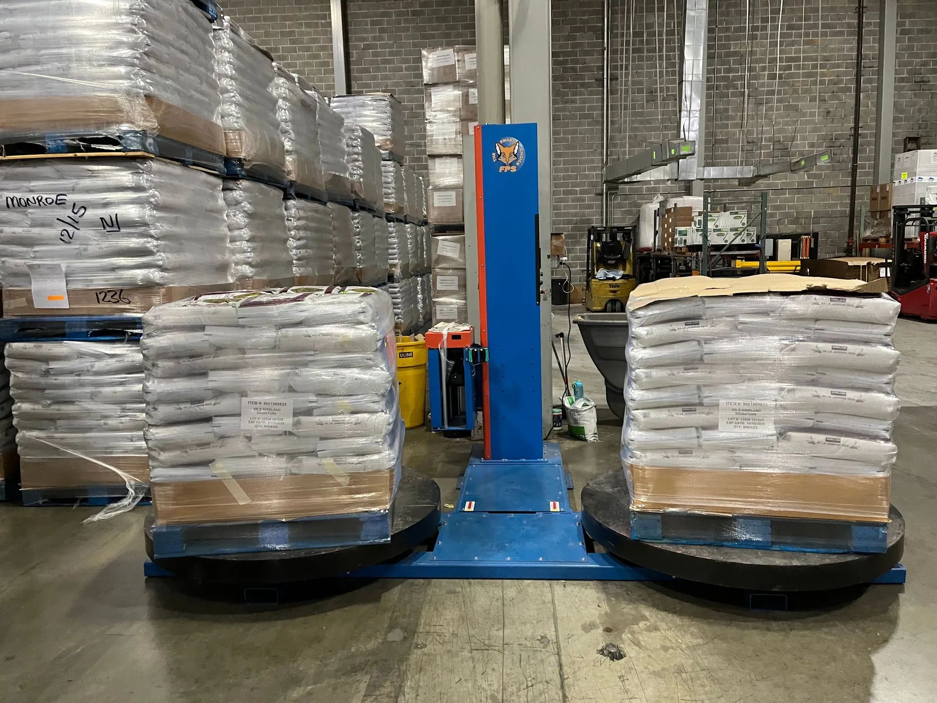 Three rolls of clear plastic wrap are stacked on top of each other on a blue background.