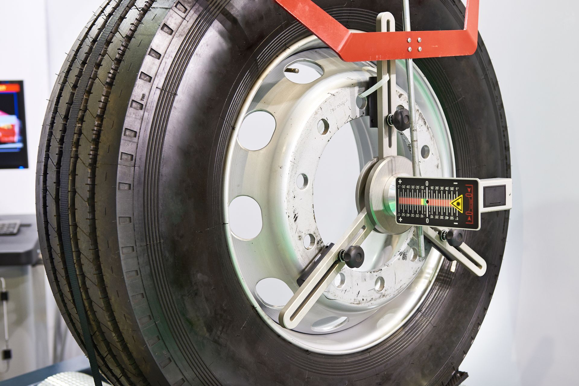 A Close Up Of A Tire Being Adjusted By A Machine — Geisler Truck & Trailer Wheel Alignments In Nebo, QLD