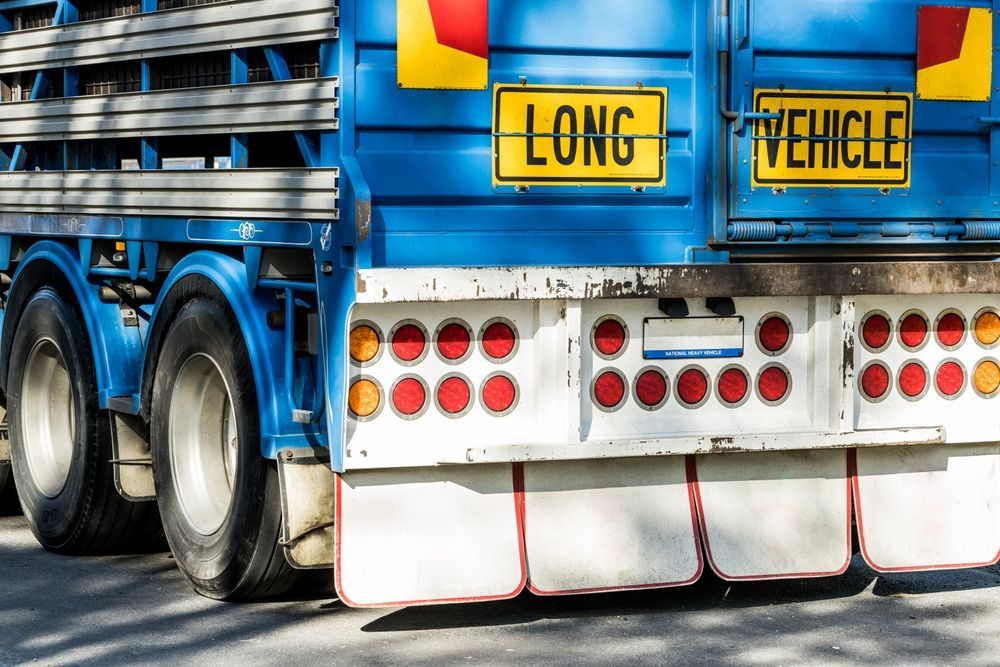 A Blue Truck With A Yellow Sign That Says Long Vehicle — Geisler Truck & Trailer Wheel Alignments In Pleystowe, QLD