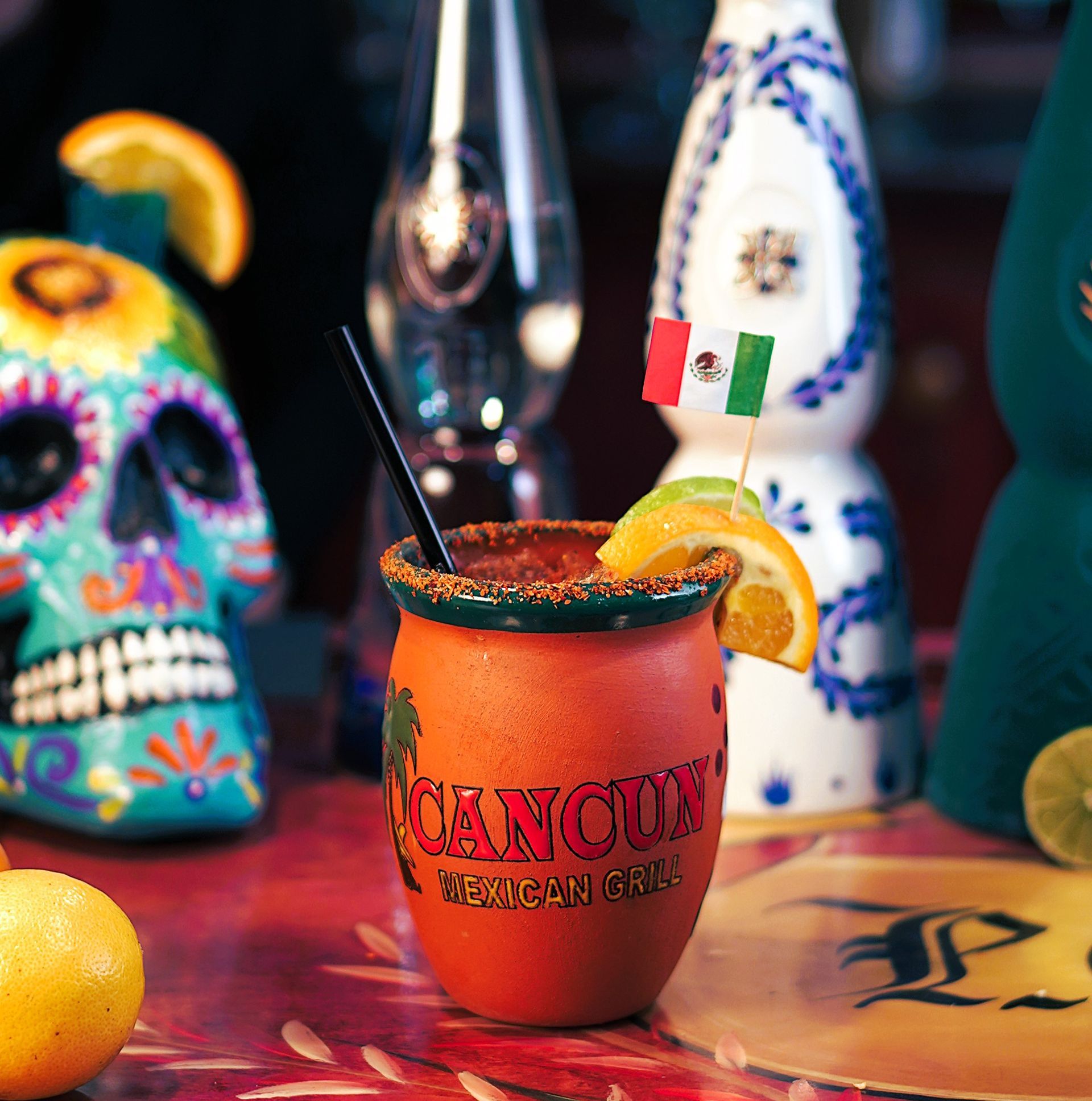 A cancun mexican drink with a straw in it