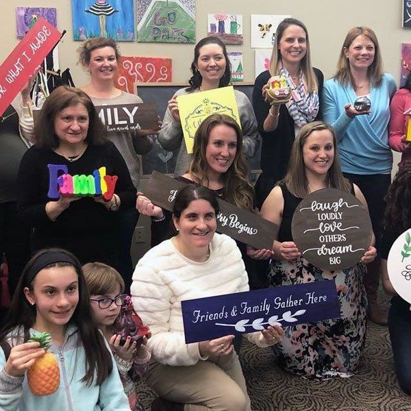 ladies holding their paintings