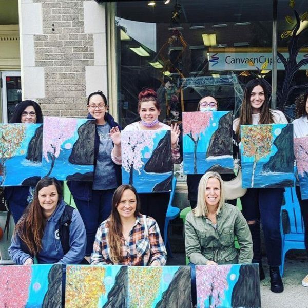 ladies holding their paintings