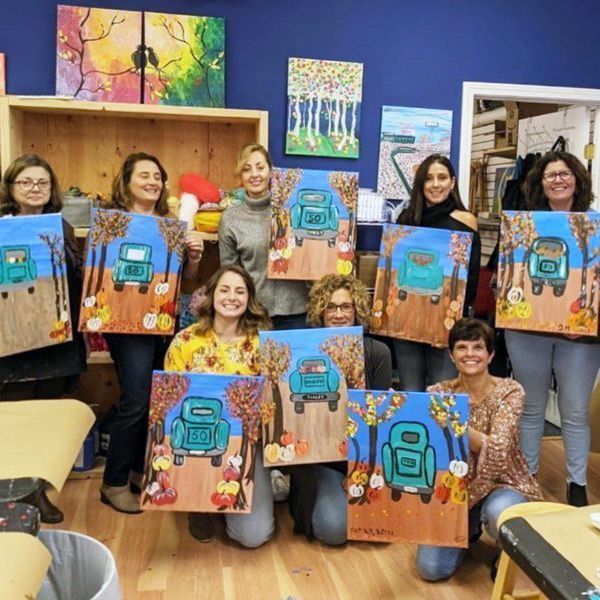 ladies holding their paintings