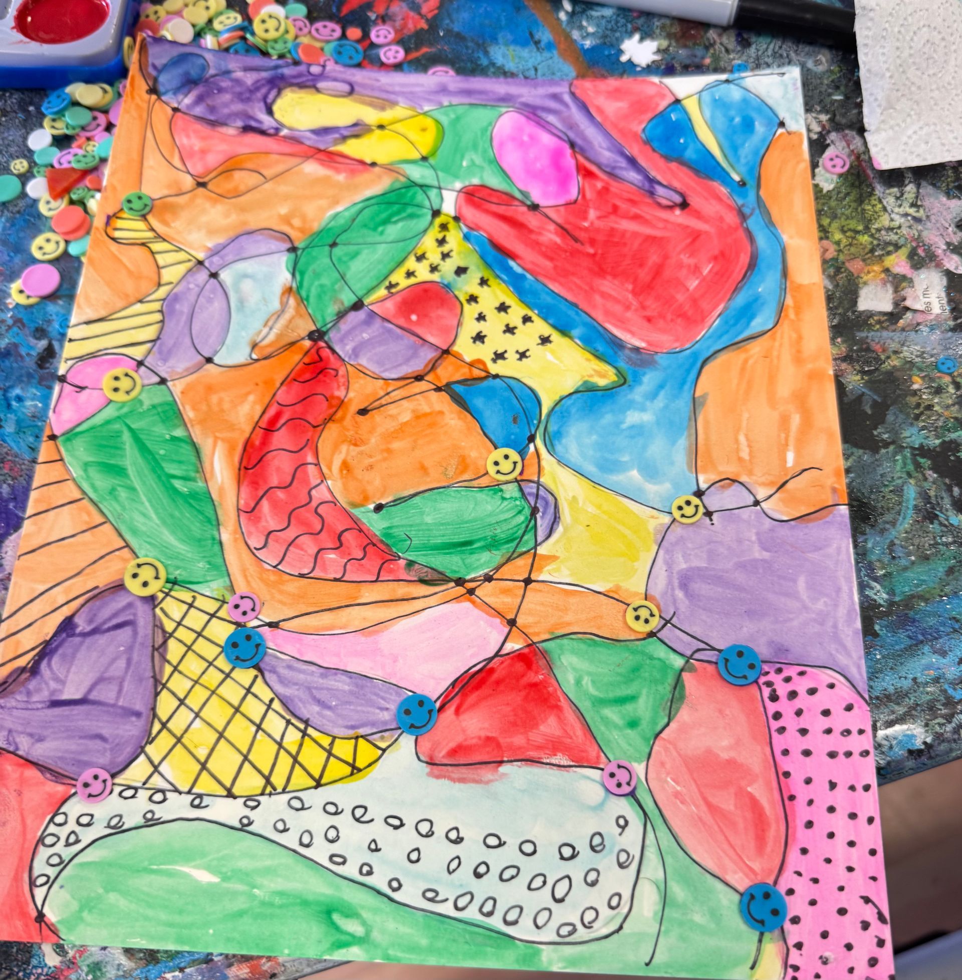 Colorful abstract painting with overlapping fish-like shapes, dots, and bright orange, pink, green, and blue sections