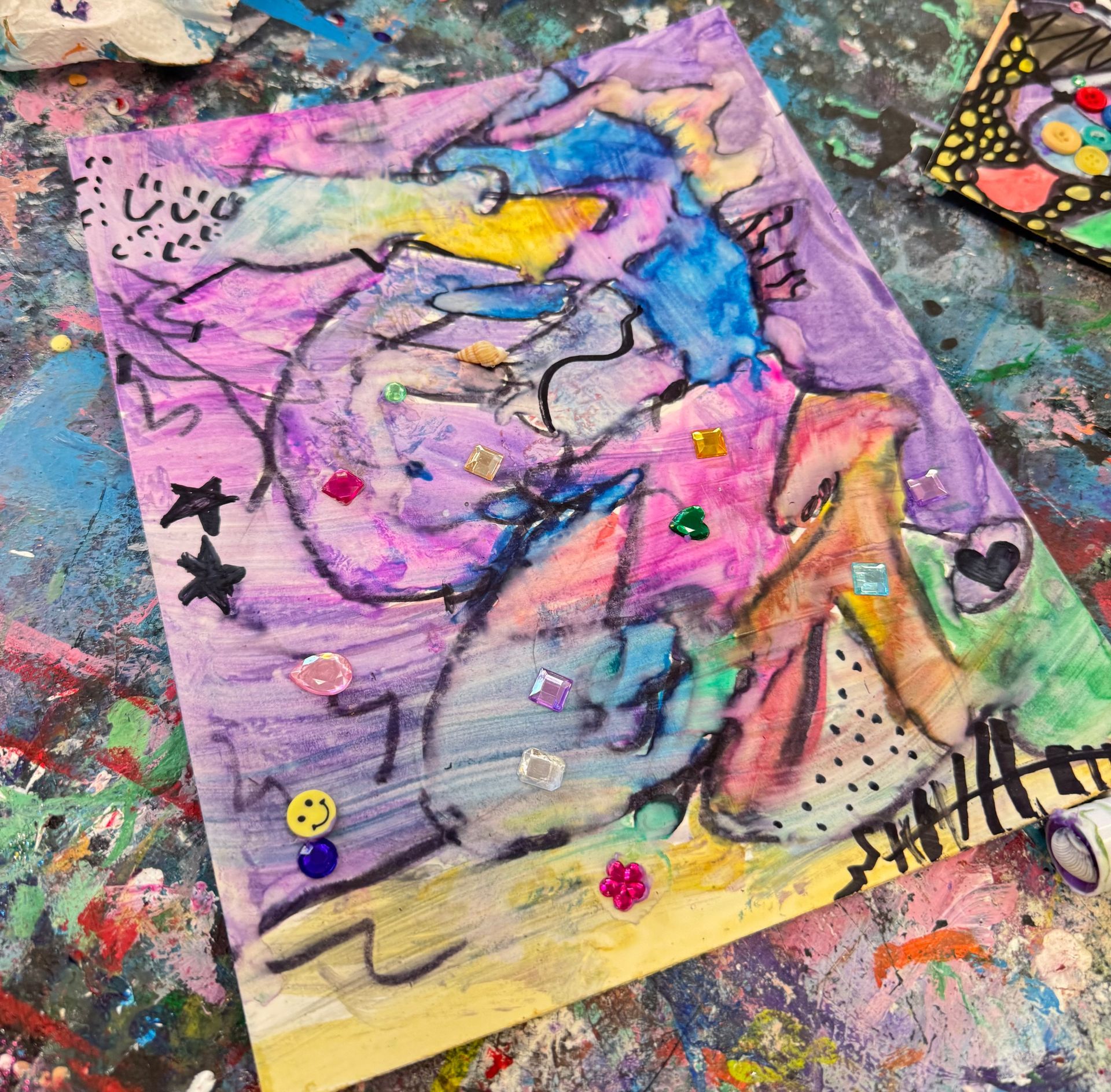 Abstract colorful painting with a bird-like figure on a paint-splattered surface