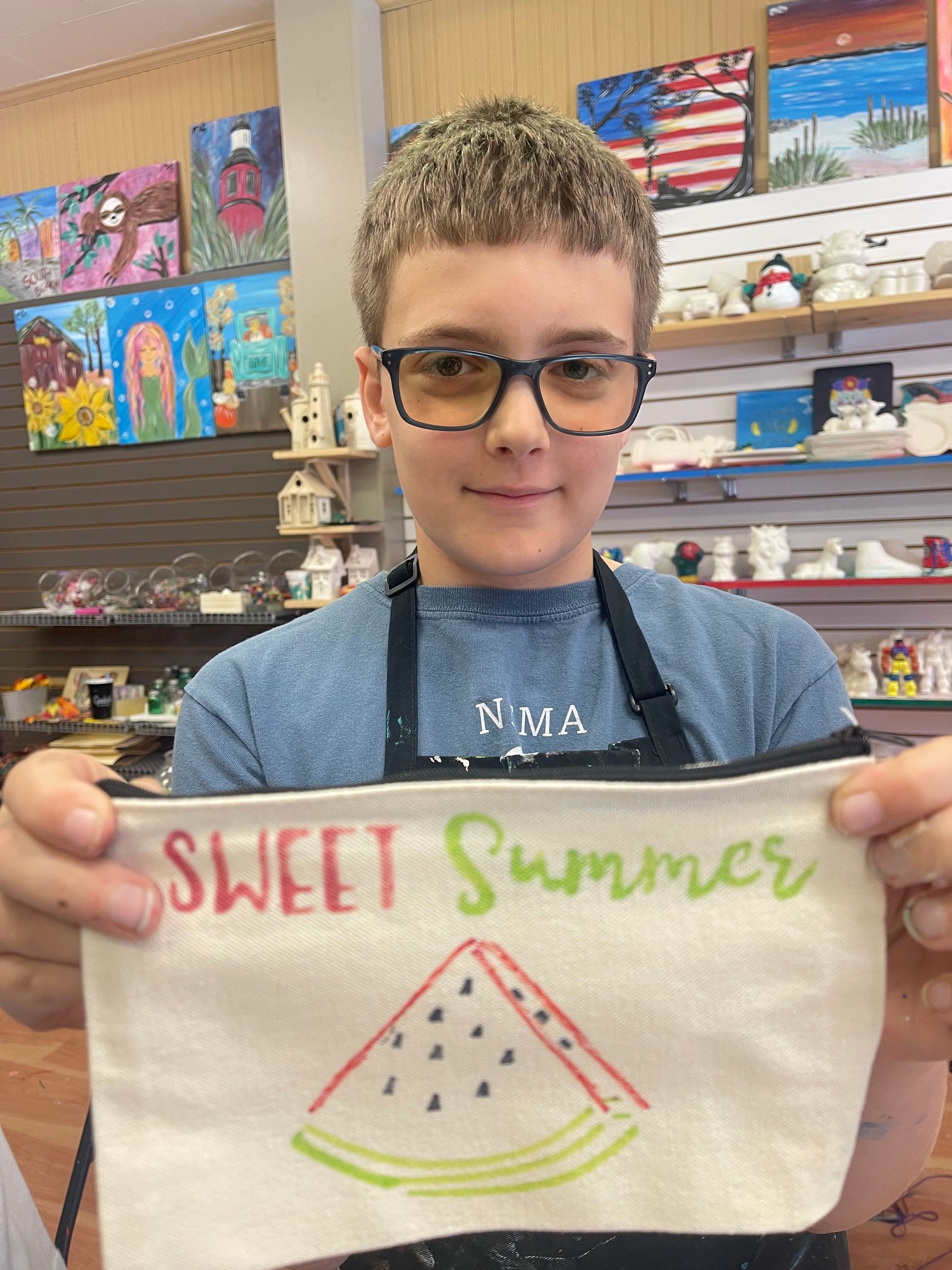A young boy is holding a sign that says sweet summer