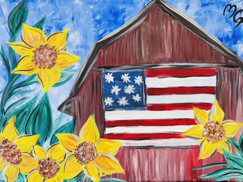 Hand-painted American flag on a red barn with yellow sunflowers and a blue sky background