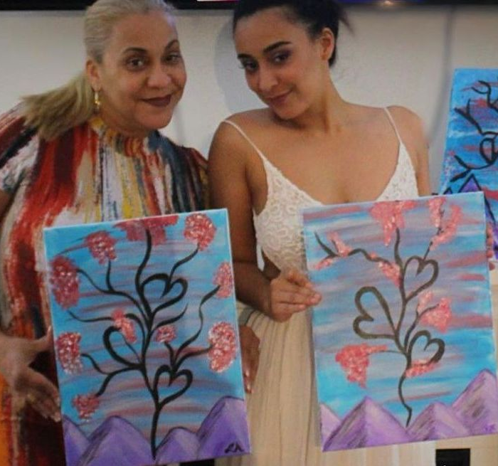 woman holding thanksgiving painting