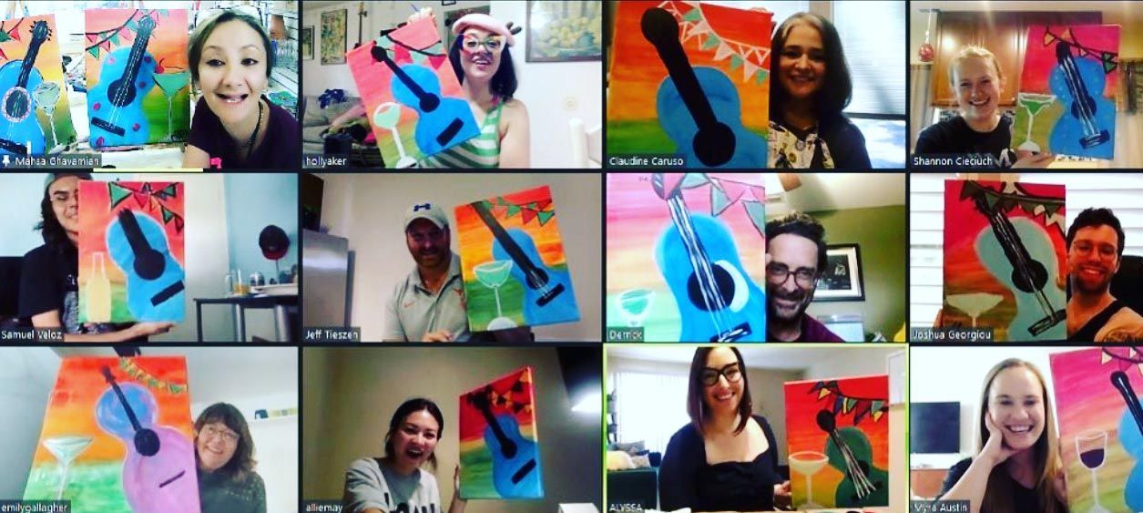 A group of people are sitting in front of a wall with guitars painted on it.
