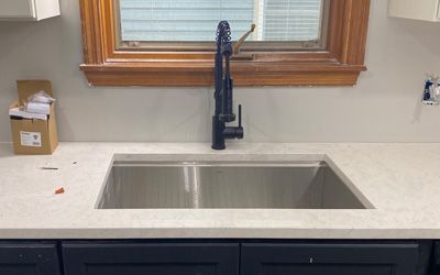 a bathroom with sink fixtures, bathtub fixtures, and a reflection of shower fixtures