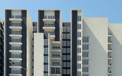 a large building with a lot of windows and balconies on a sunny day