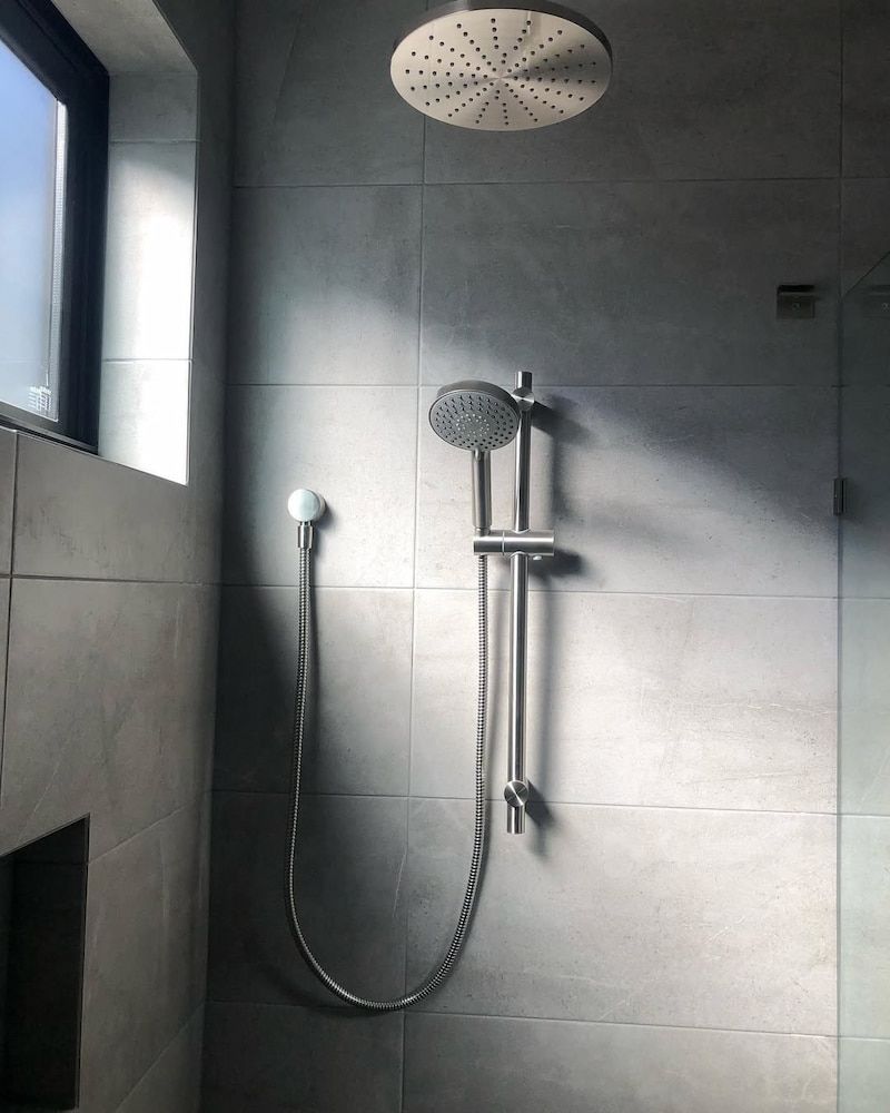 A Shower Head is Hanging From the Ceiling in a Bathroom — Peak Plumbing and Gas Fitting in Yamba, NSW