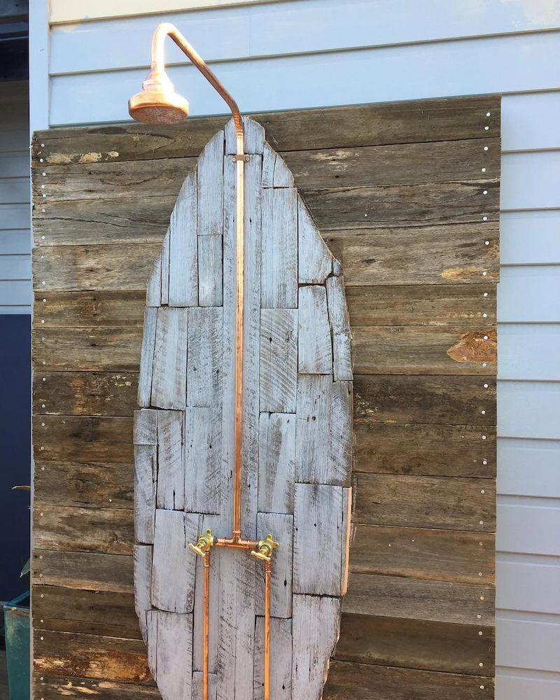 A Surfboard With a Shower Attached to It — Peak Plumbing and Gas Fitting in Yamba, NSW