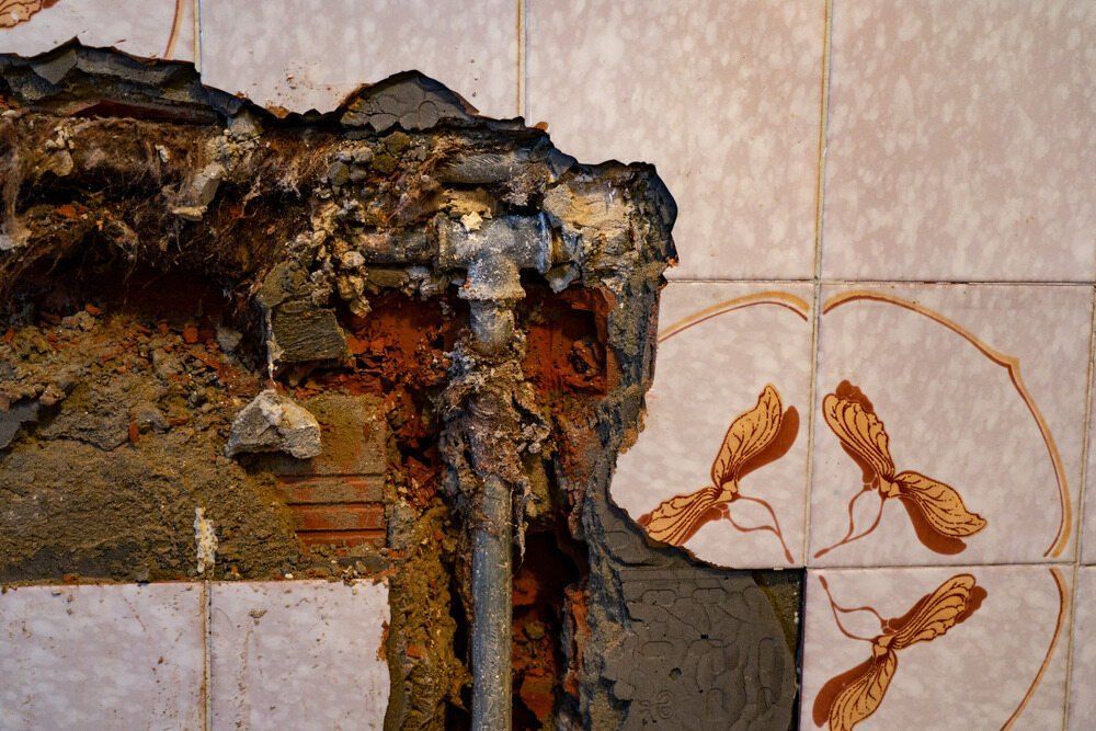 A Close Up of a Wall With a Hole in It — Peak Plumbing and Gas Fitting in Ballina, NSW