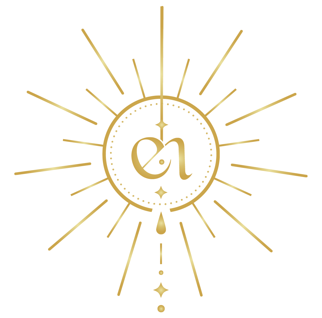 Gold monogram in a sunburst with hanging beads on a white background