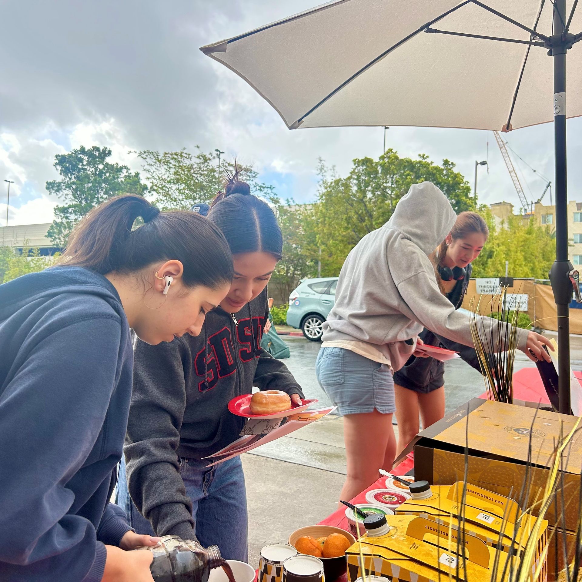 Residents enjoying coffee and donuts at Hardy Apartments community event