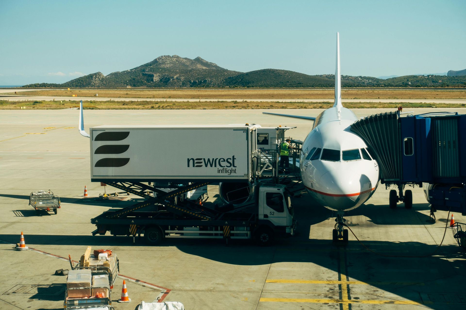 An airplane is being loaded with luggage at an airport.