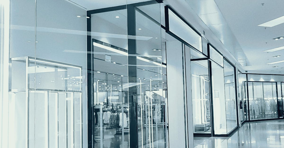 Modern glass office lobby with bright reflections and transparent walls