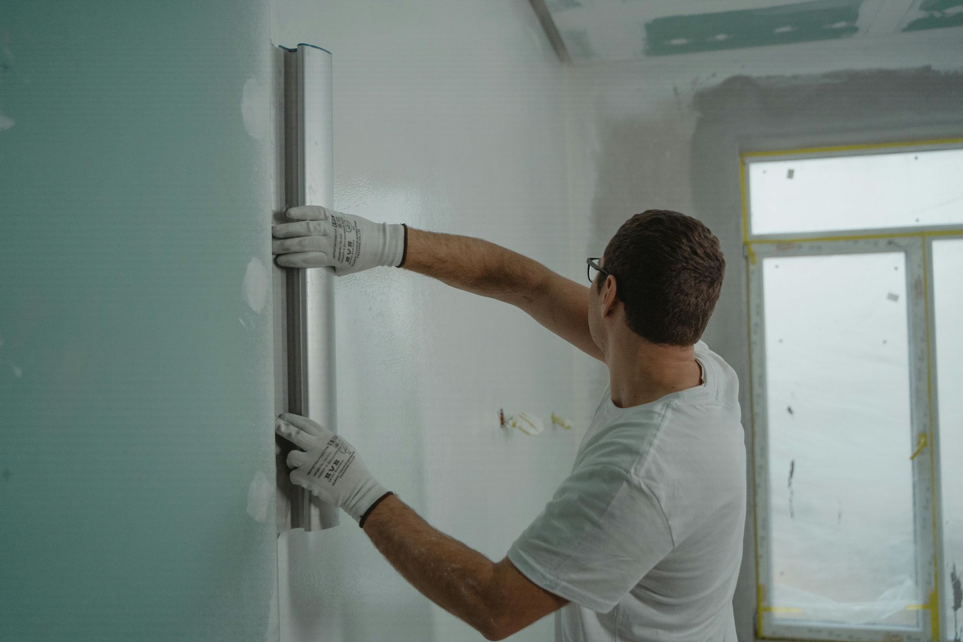 professional installer applying window film to a large residential window - window tint jacksonville beach fl