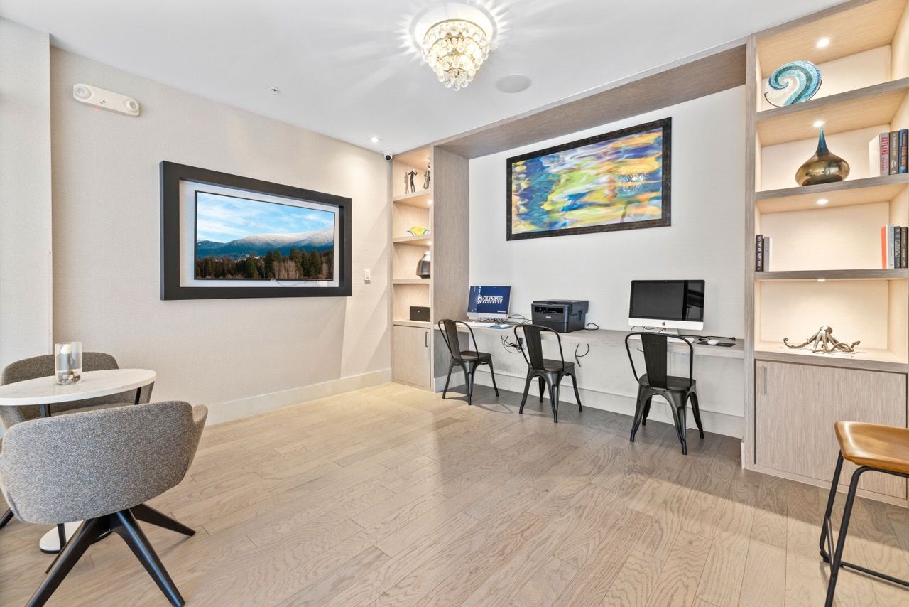 Modern communal work area with computer stations, built-in counter, and shelving at 930 Central Flats, offering apartments for rent in St. Petersburg.
