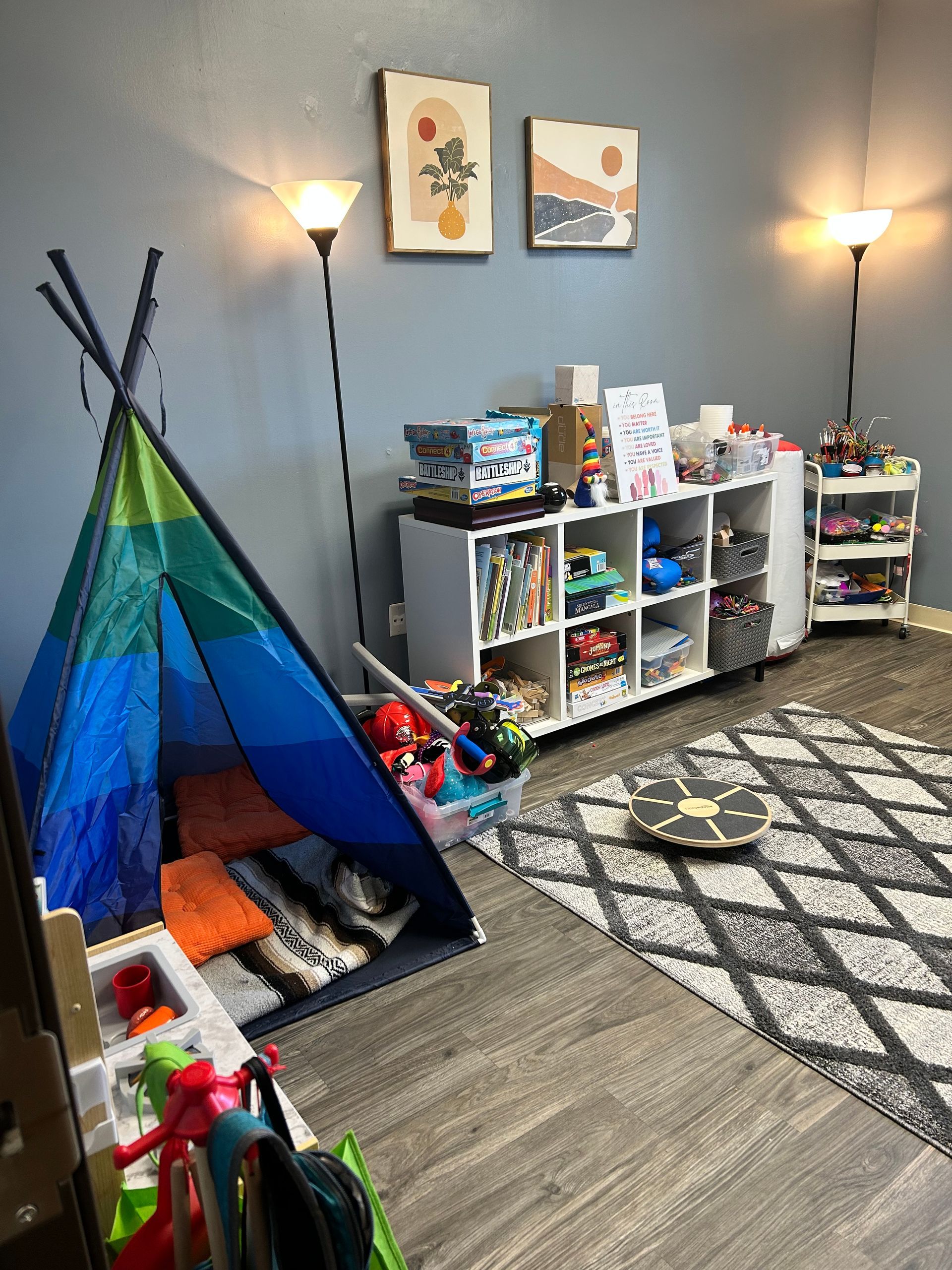 a room at Peck Counseling filled with lots of toys and a teepee .