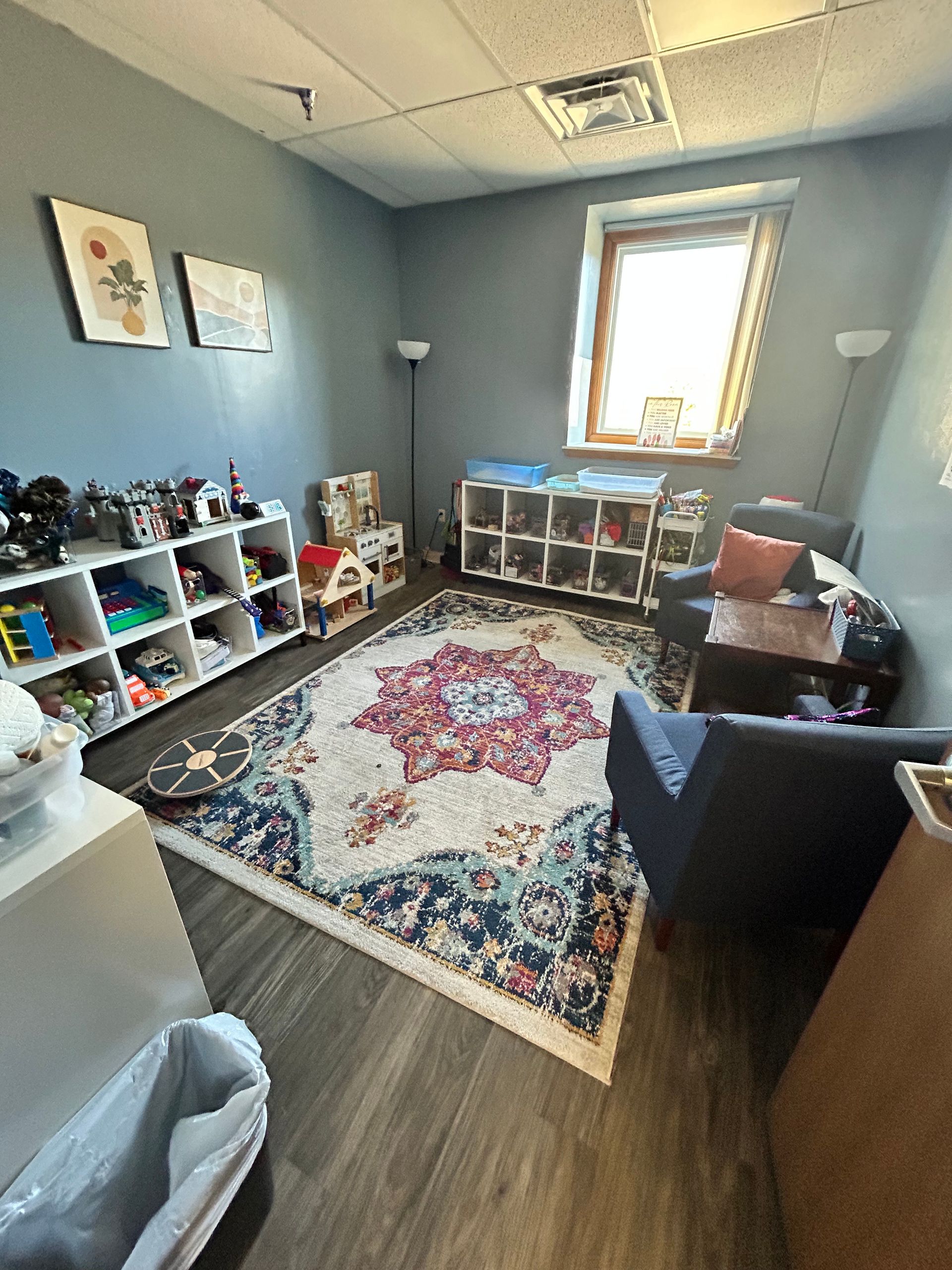 a room at Peck Counseling filled with lots of toys and a teepee .