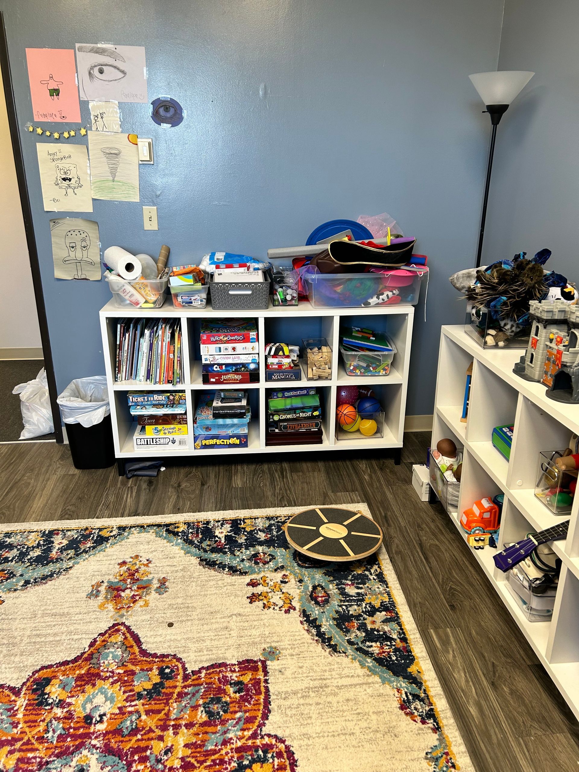 Peck Counseling's assortment of toys for play therapy and more sitting on a small, open dresser.