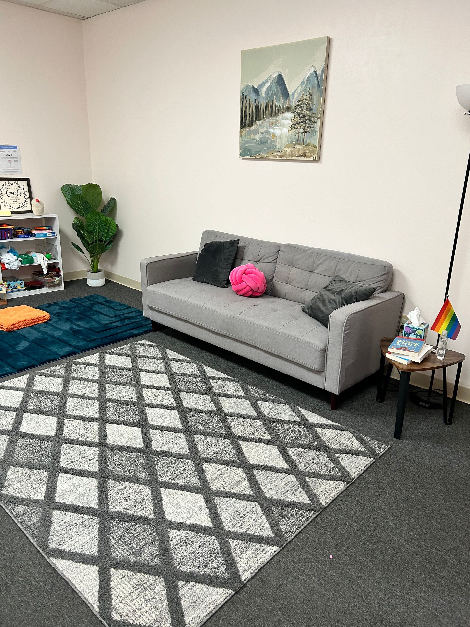 Peck Counseling's space for therapy, with a couch , chair , and rug .