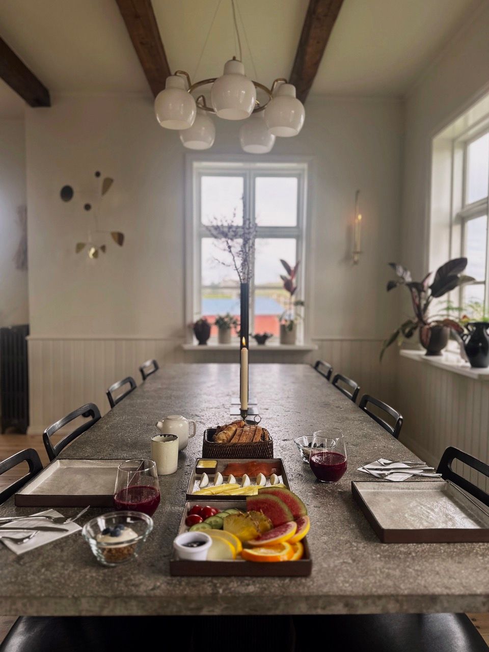a dining room table with a tray of fruit on it