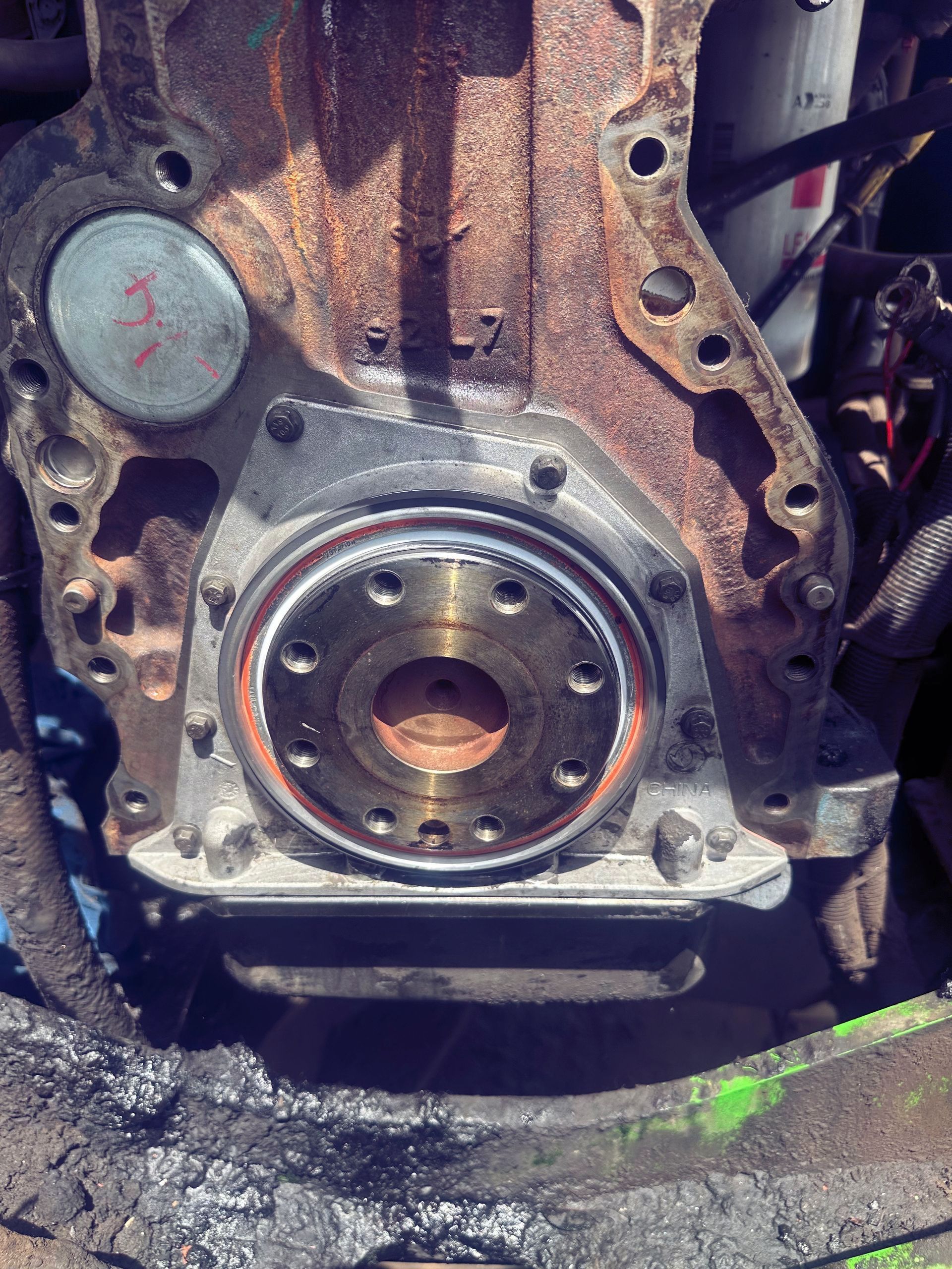 A close up of a rusty engine with a bearing on it