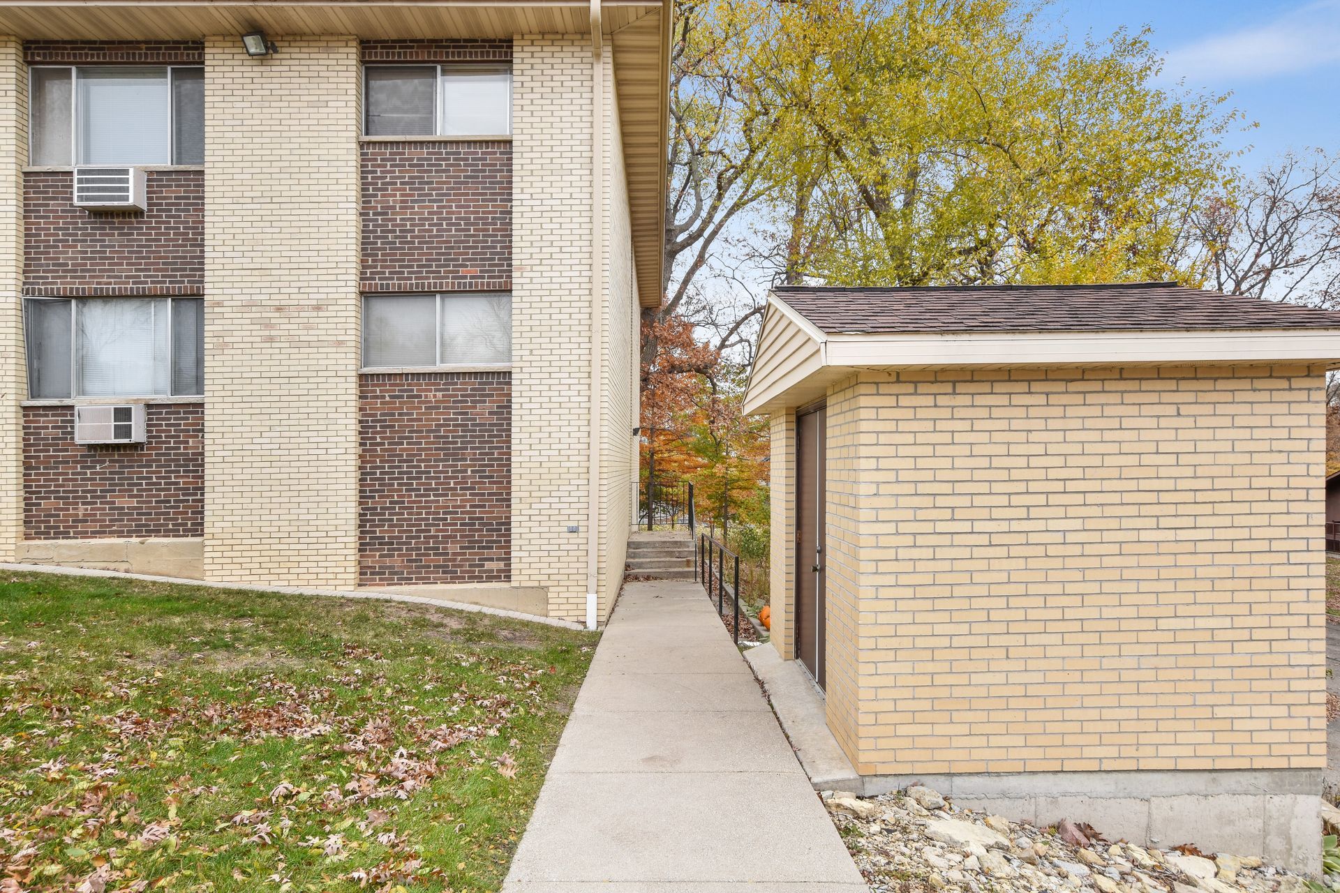 A brick building with a walkway leading to it
