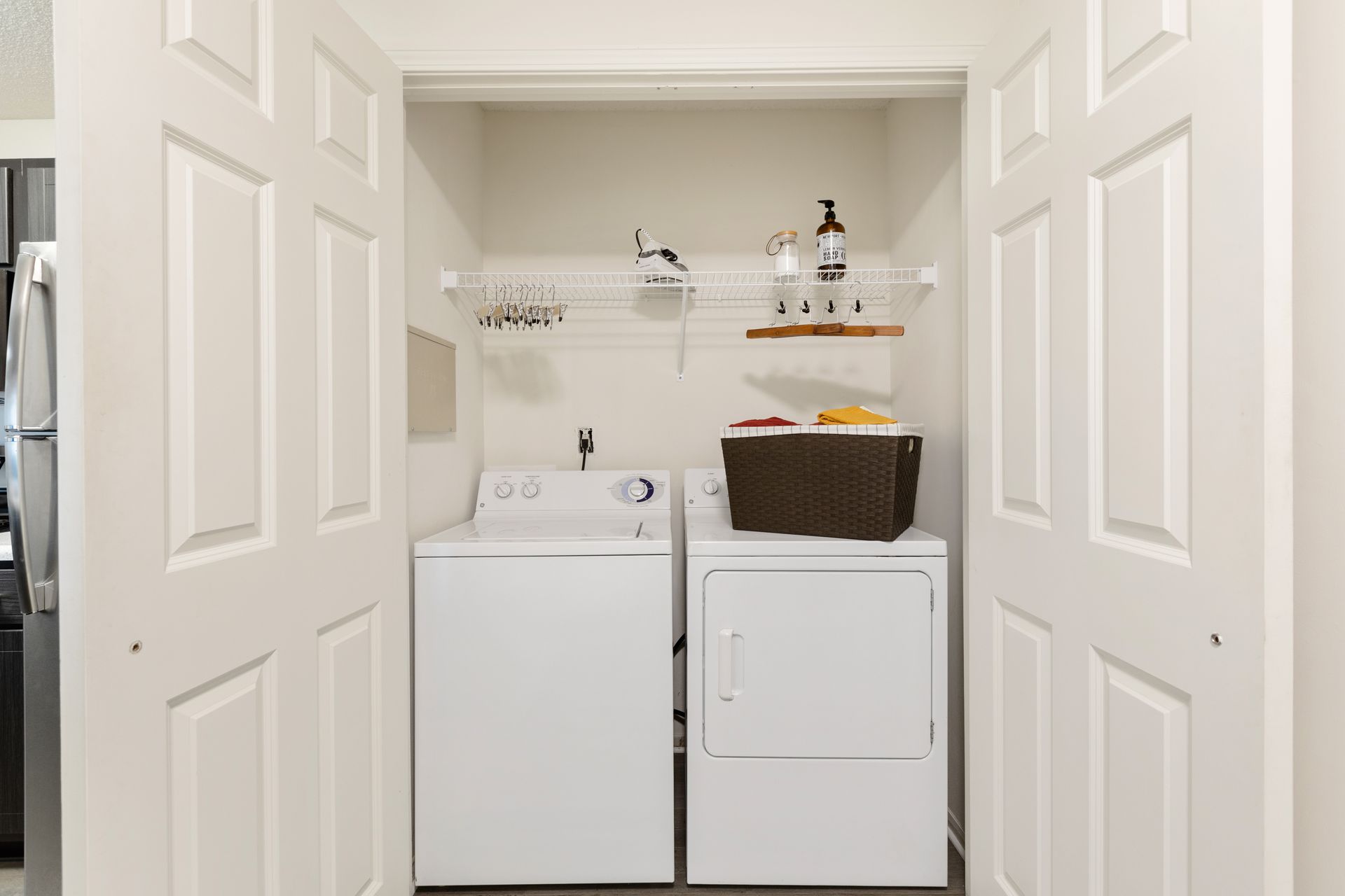 A laundry room with a washer and dryer in a closet.