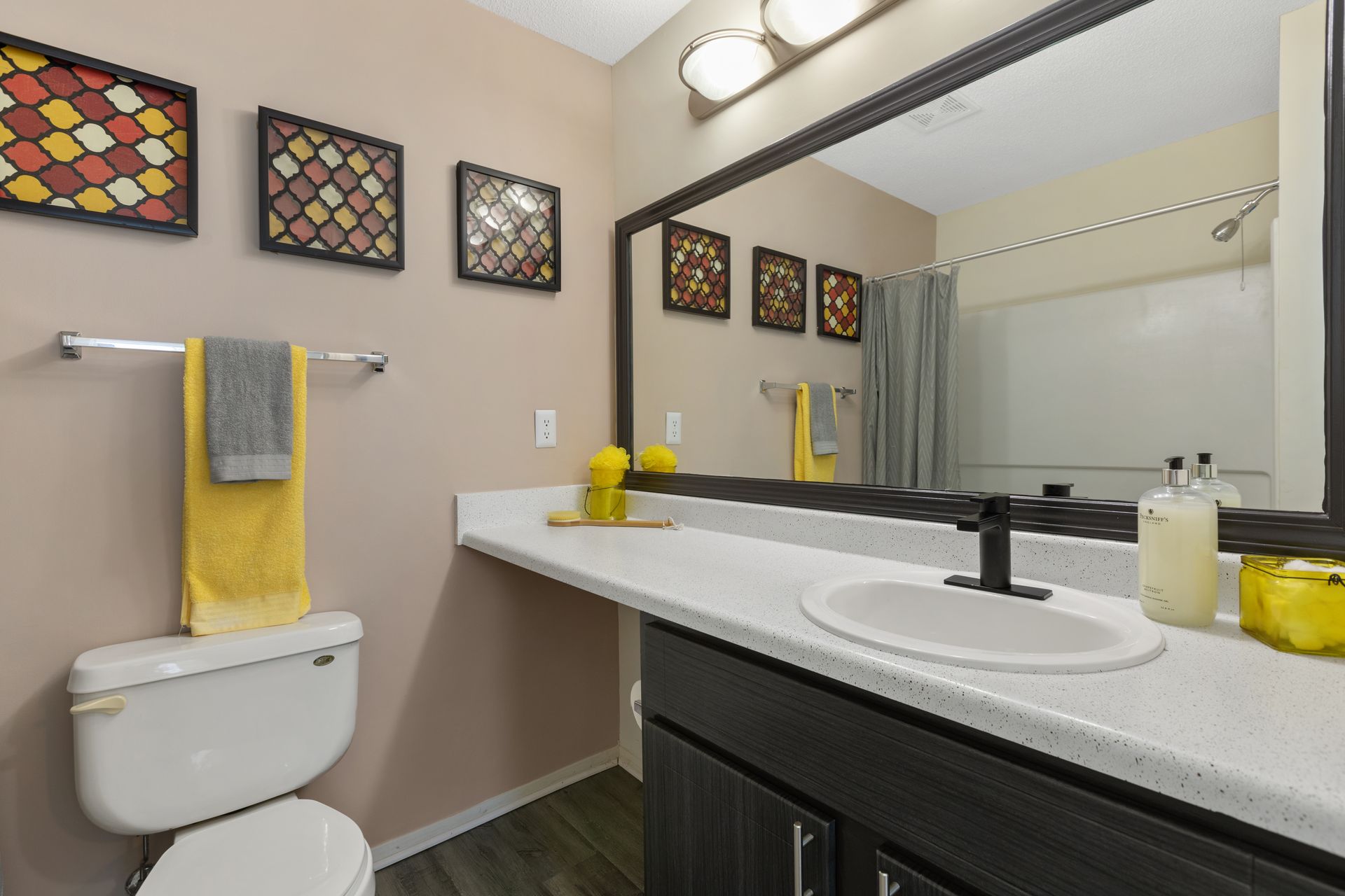 A bathroom with a toilet , sink , and mirror.