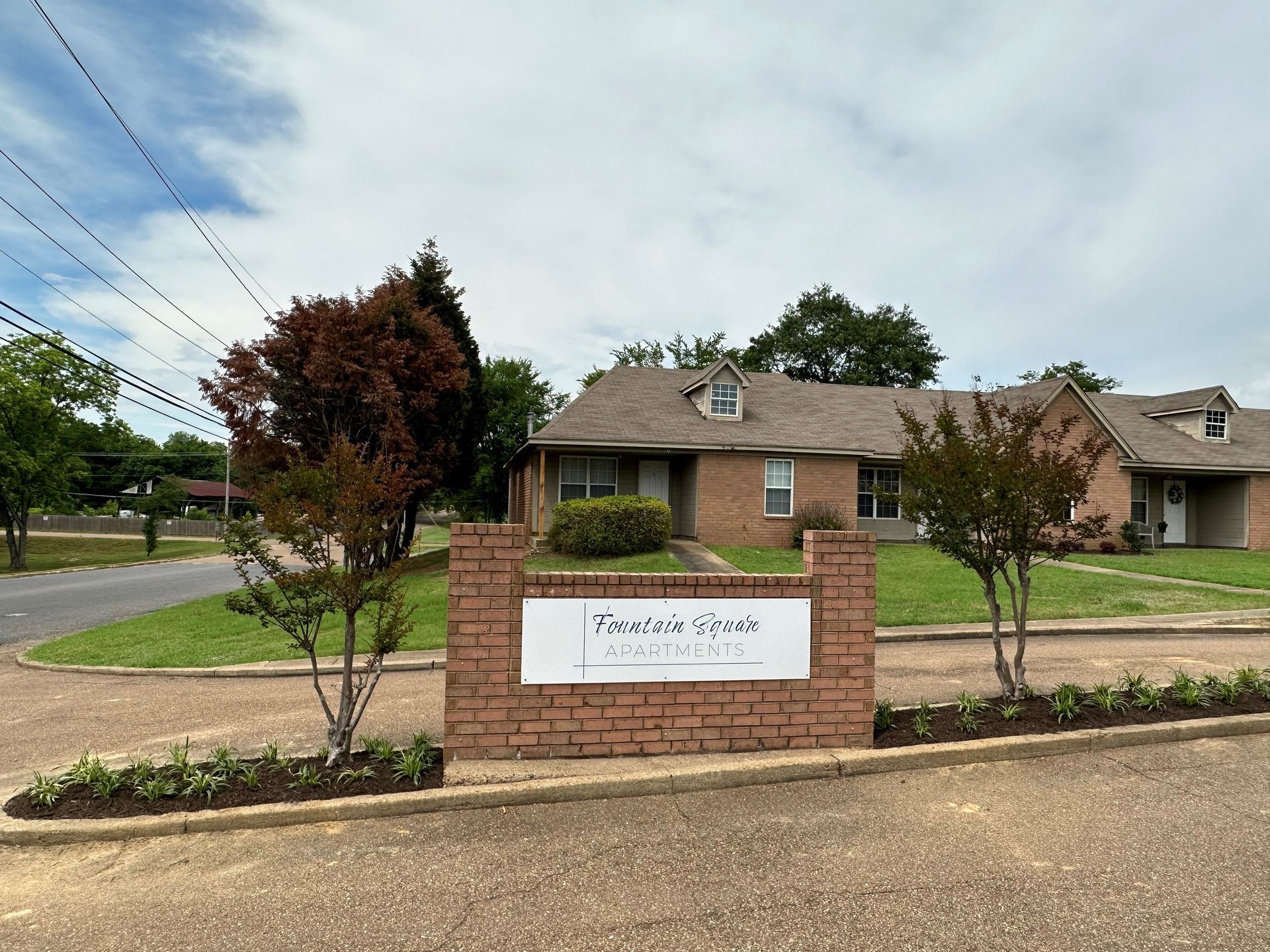 A brick building with a sign in front of it