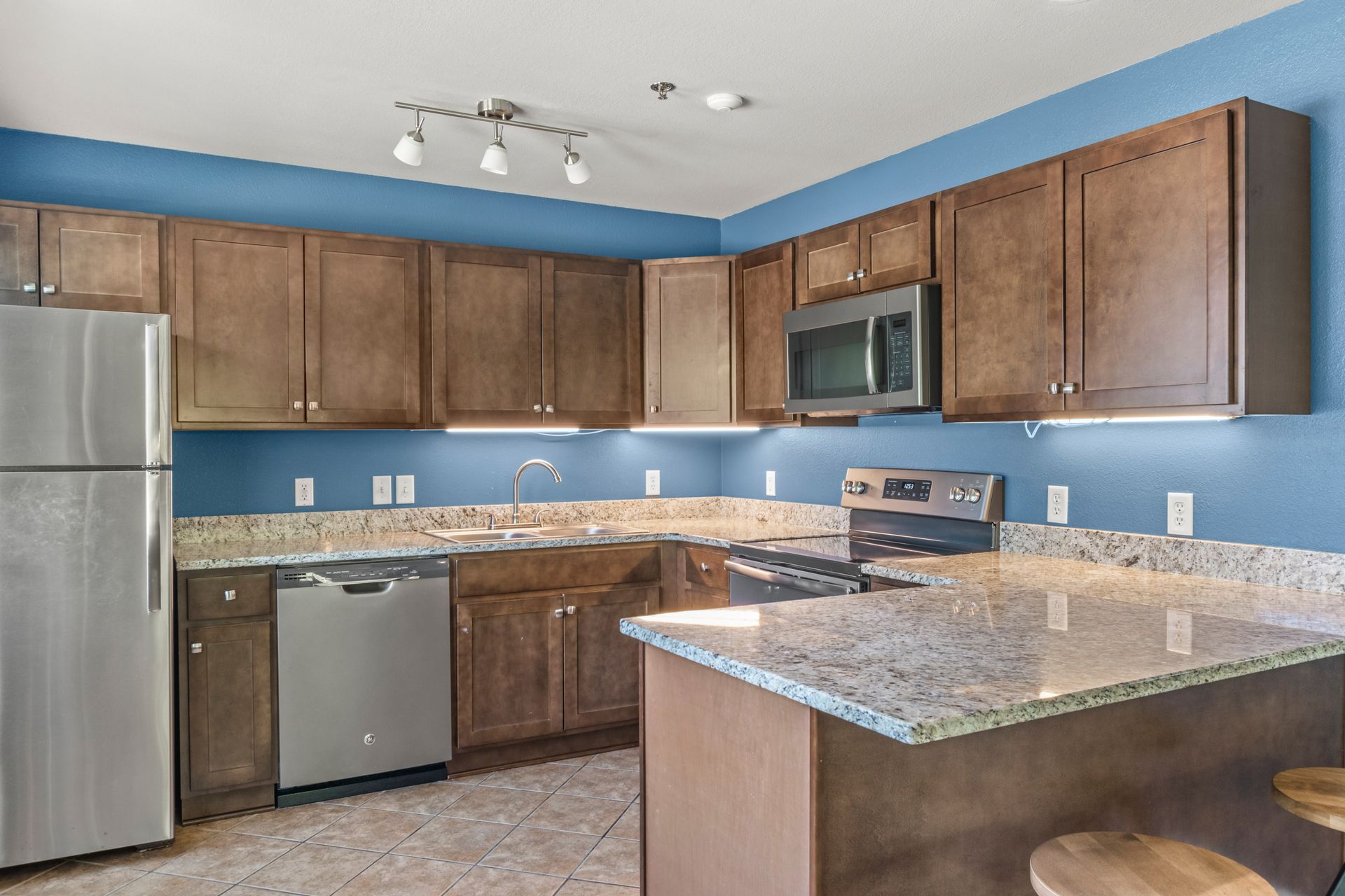 A kitchen with stainless steel appliances and granite counter tops