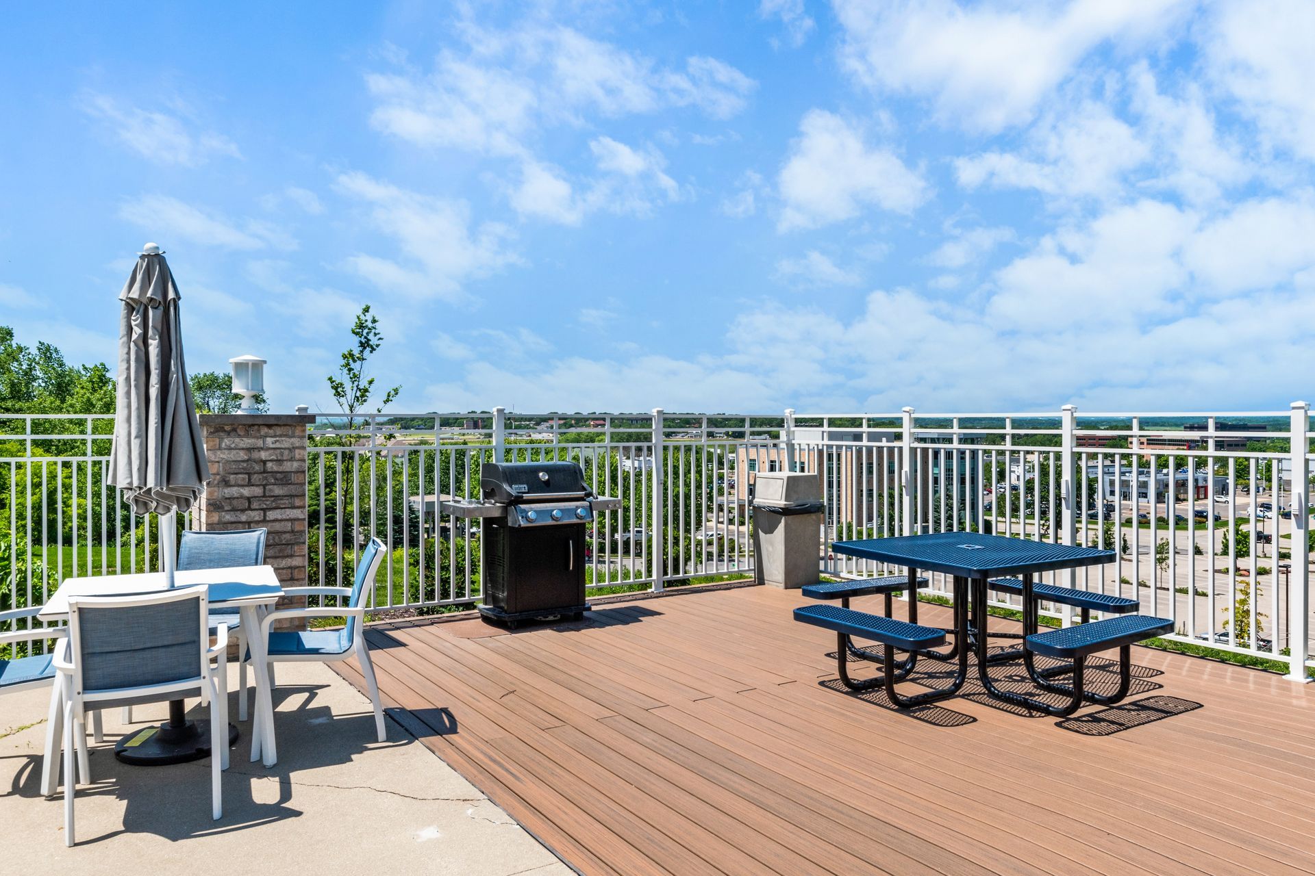 There is a picnic table and a grill on the deck.