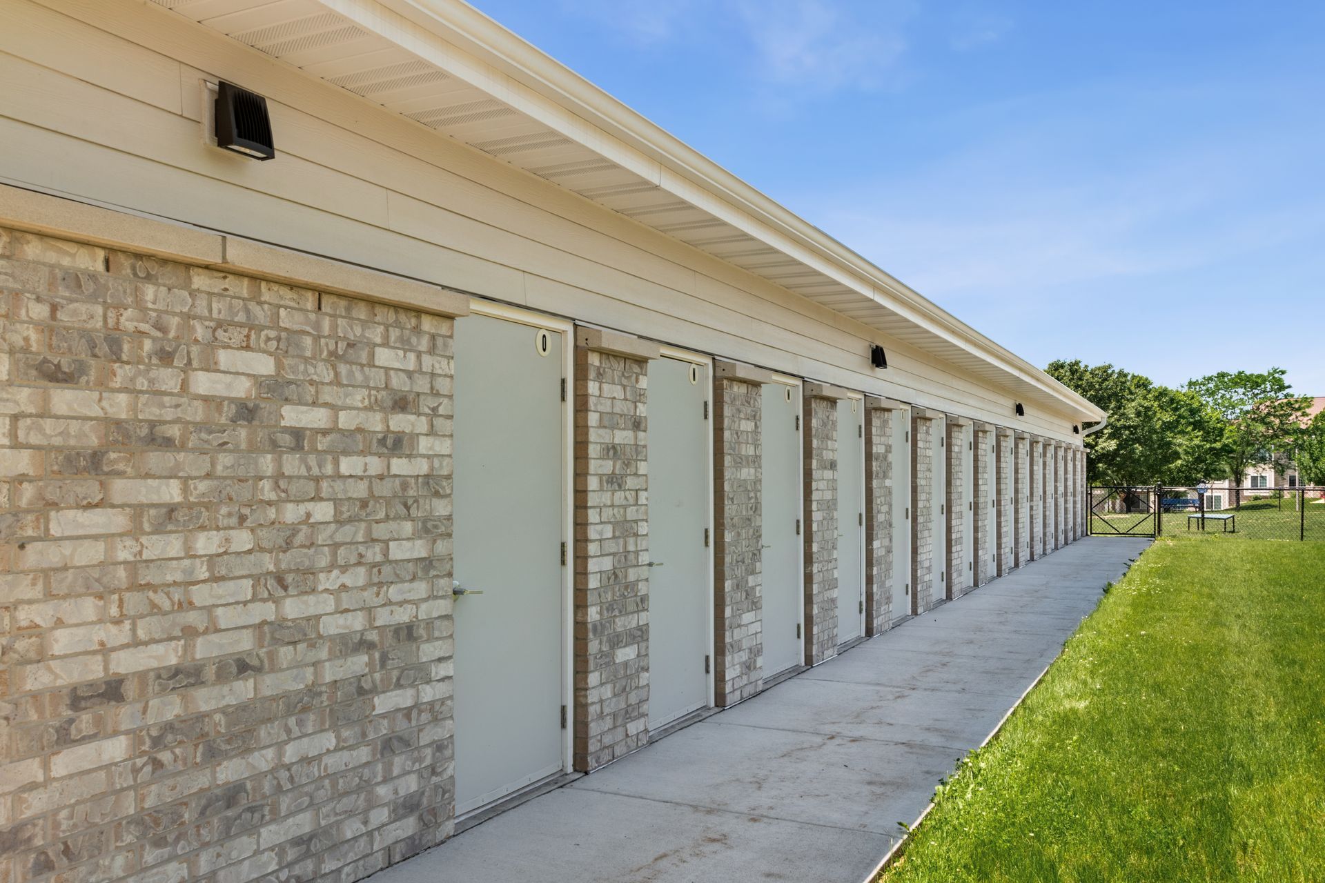 A brick building with a row of doors on it