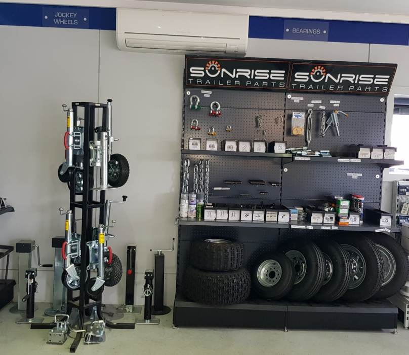 A display of wheels and tires on a stand in a store.