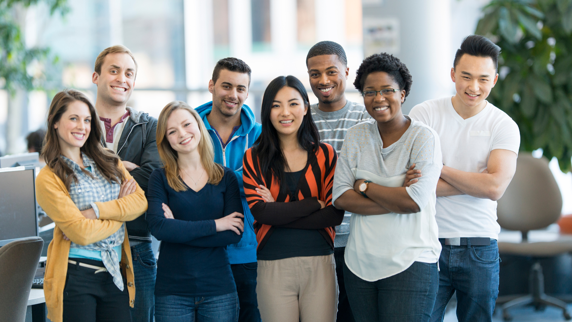 A group of young people are standing around a table in a classroom.