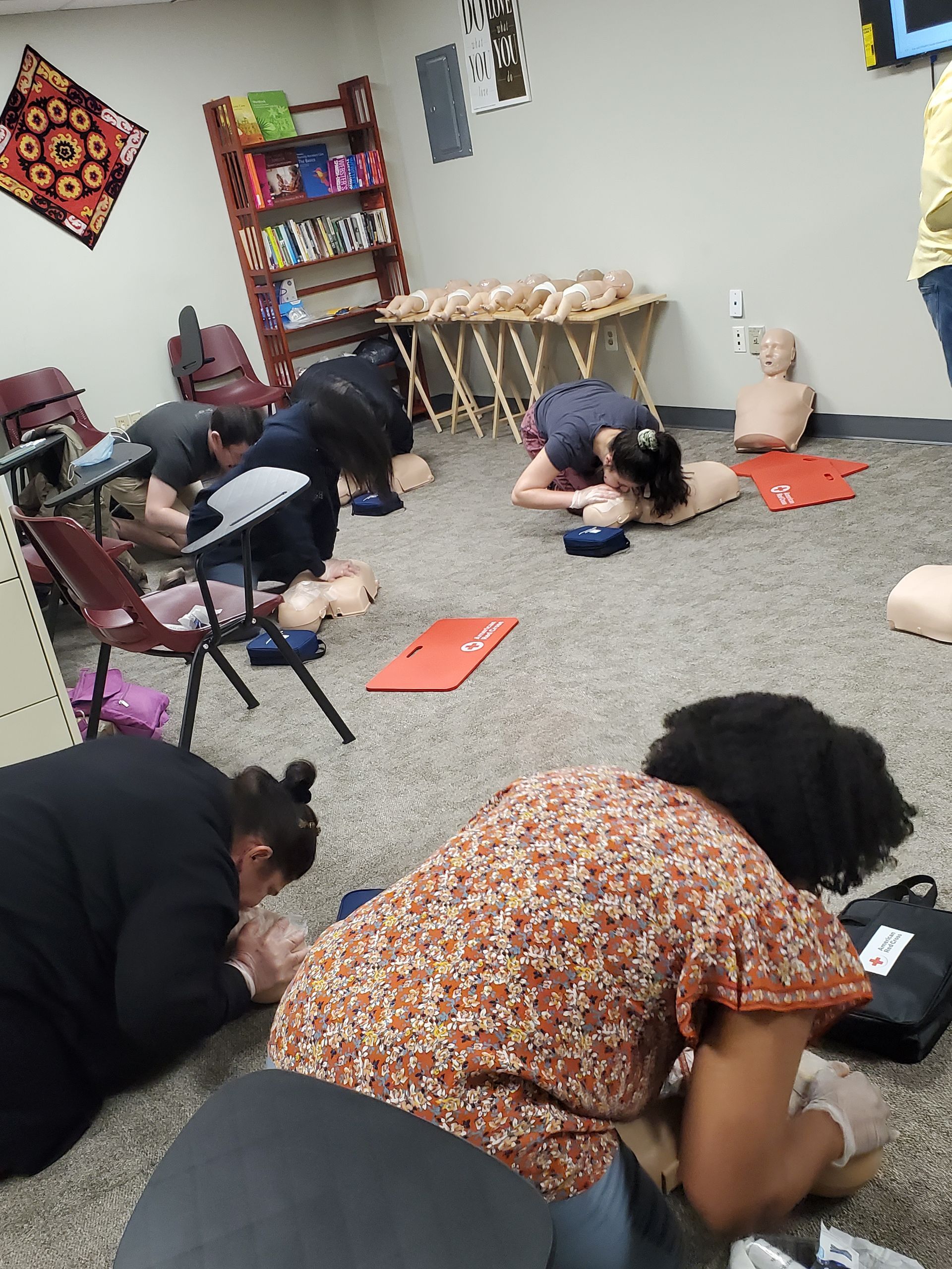 A group of people are kneeling on the floor in a room.