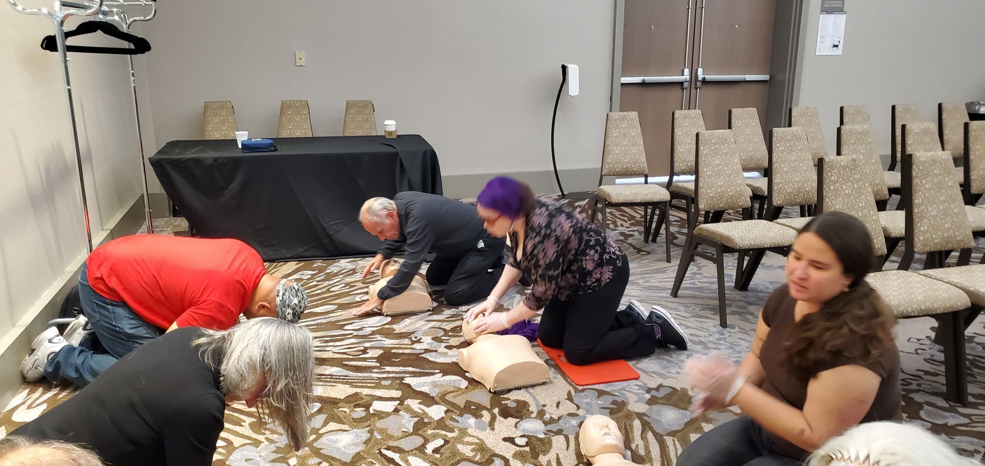 A group of people are kneeling on the floor in a room.