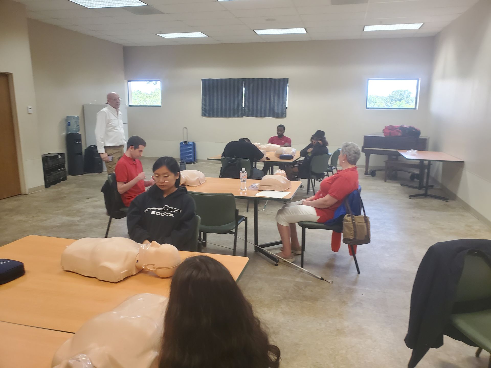 A group of people are sitting at tables in a room.