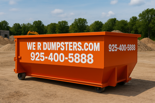 An orange roll-off dumpster on a dirt lot, labeled with