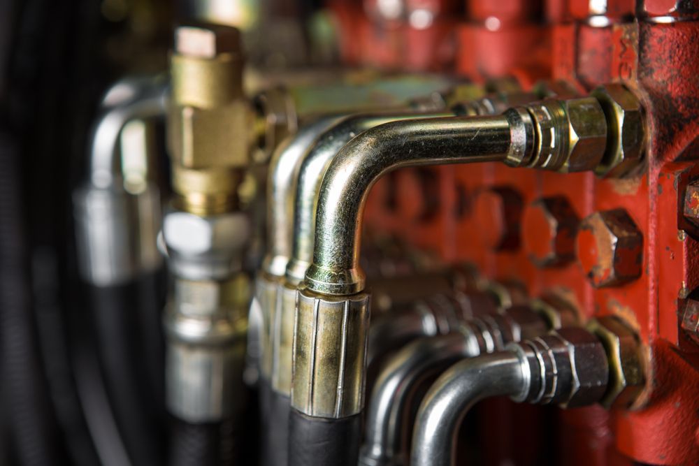 Close-up of Hydraulic Lines and Fittings on a Red Mechanical Component — Alloway Hydraulics in Mount Saint John, QLD