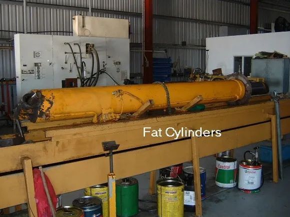 A Large Yellow Hydraulic Cylinder on a Work Bench in a Workshop — Alloway Hydraulics in Mount Saint John, QLD