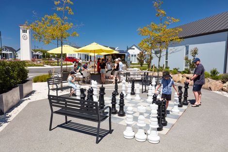 Families playing outdoor chess